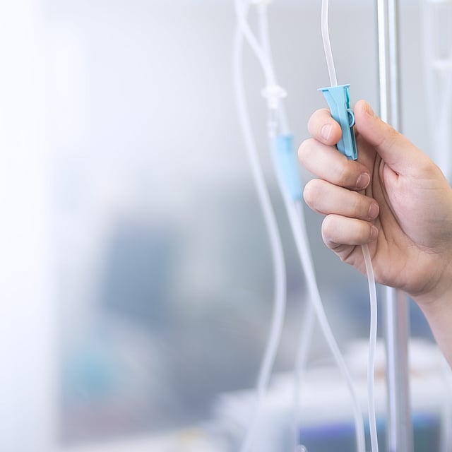 Una mano que sostiene un tubo azul con una huella de pata en él.