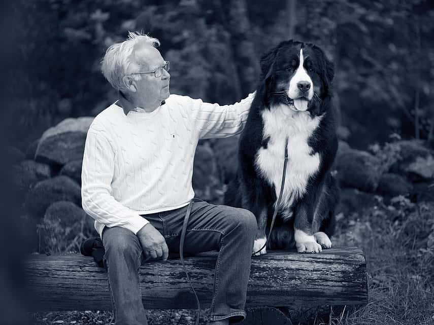 elderly man with old black and white dog