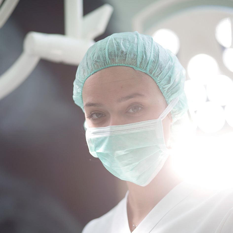 A person wearing a mask and cap.